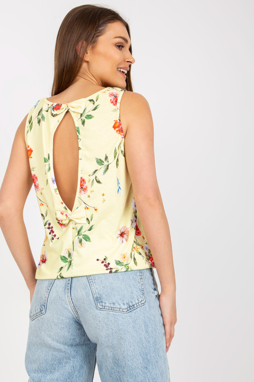 Helekollase mustriga topp, mille taga...